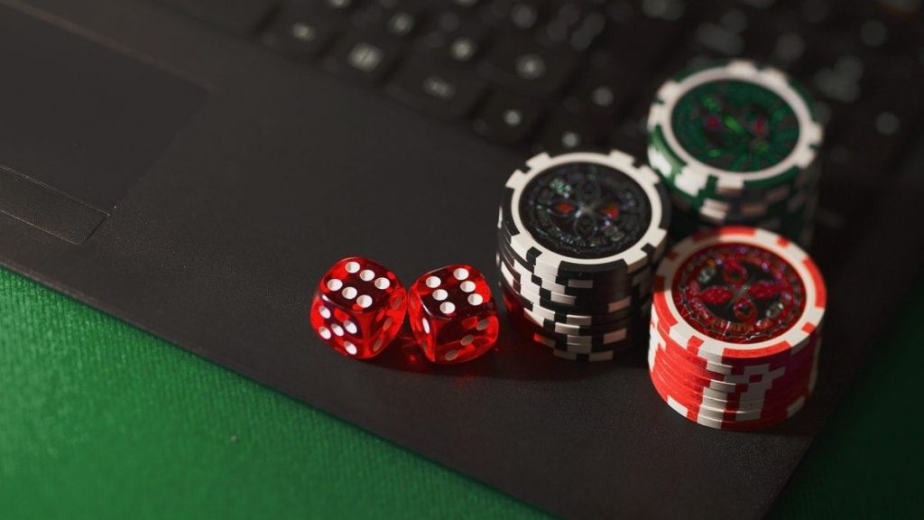 poker chips and dice on a keyboard for starting a new online casino